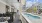 Hanging couches on a porch next to a pool