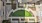  A green lawn is surrounded by buildings in this aerial view.