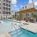 Resort-style pool with chairs and cabana