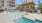 Resort-style pool with chairs and cabana
