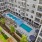  A large apartment complex with a pool and a patio area.